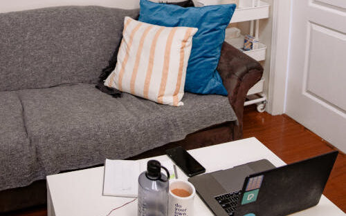 Living room with laptop setup on coffee table